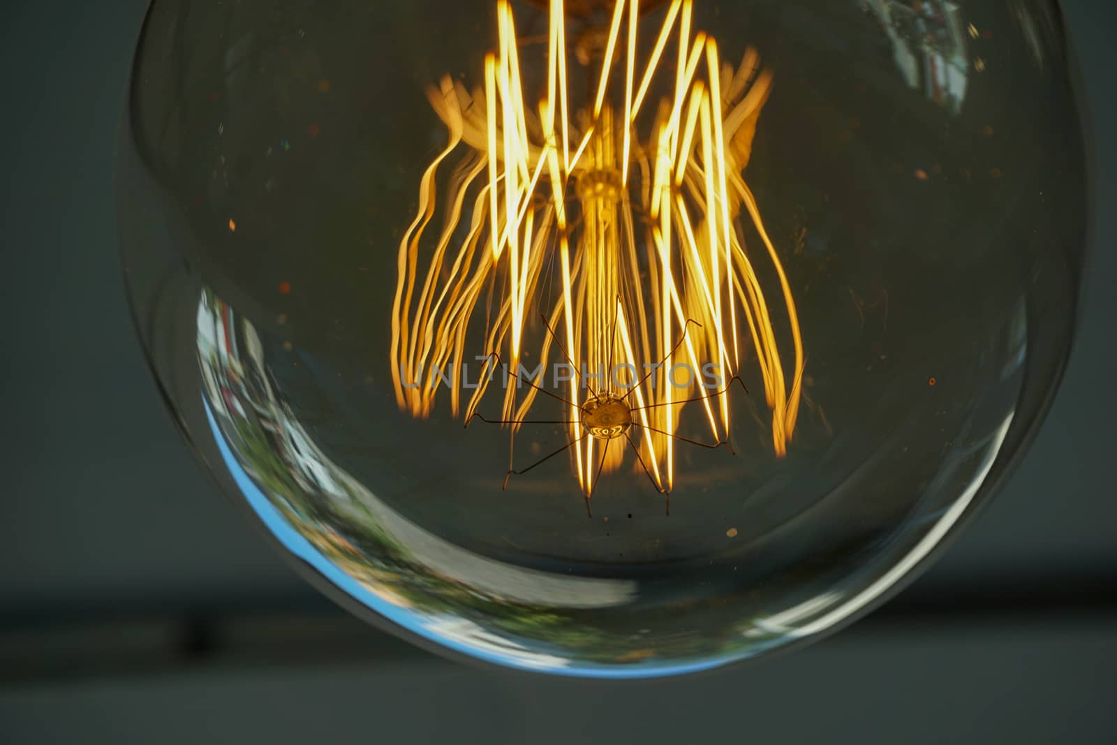 Electricity current inside a retro crystal clear light bulb.