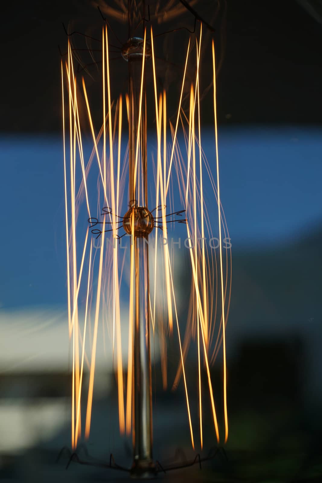 Amazing spiral electric current inside a retro crystal clear light bulb.