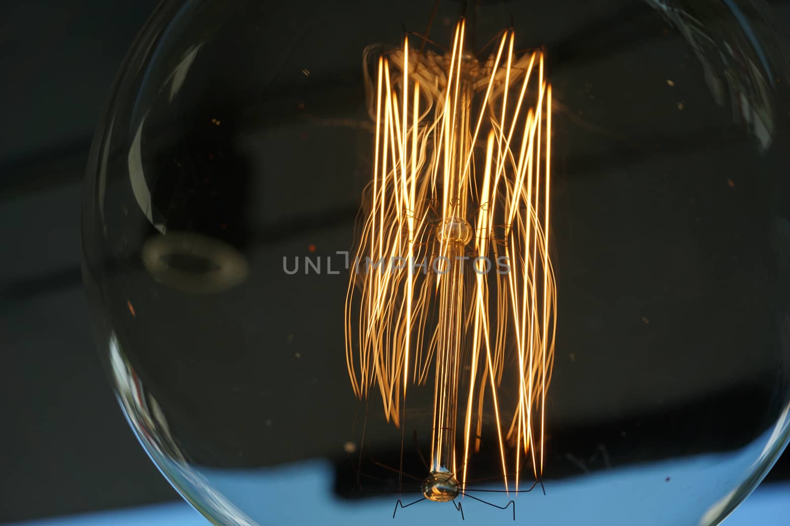 Amazing spiral electric current inside a retro crystal clear light bulb.