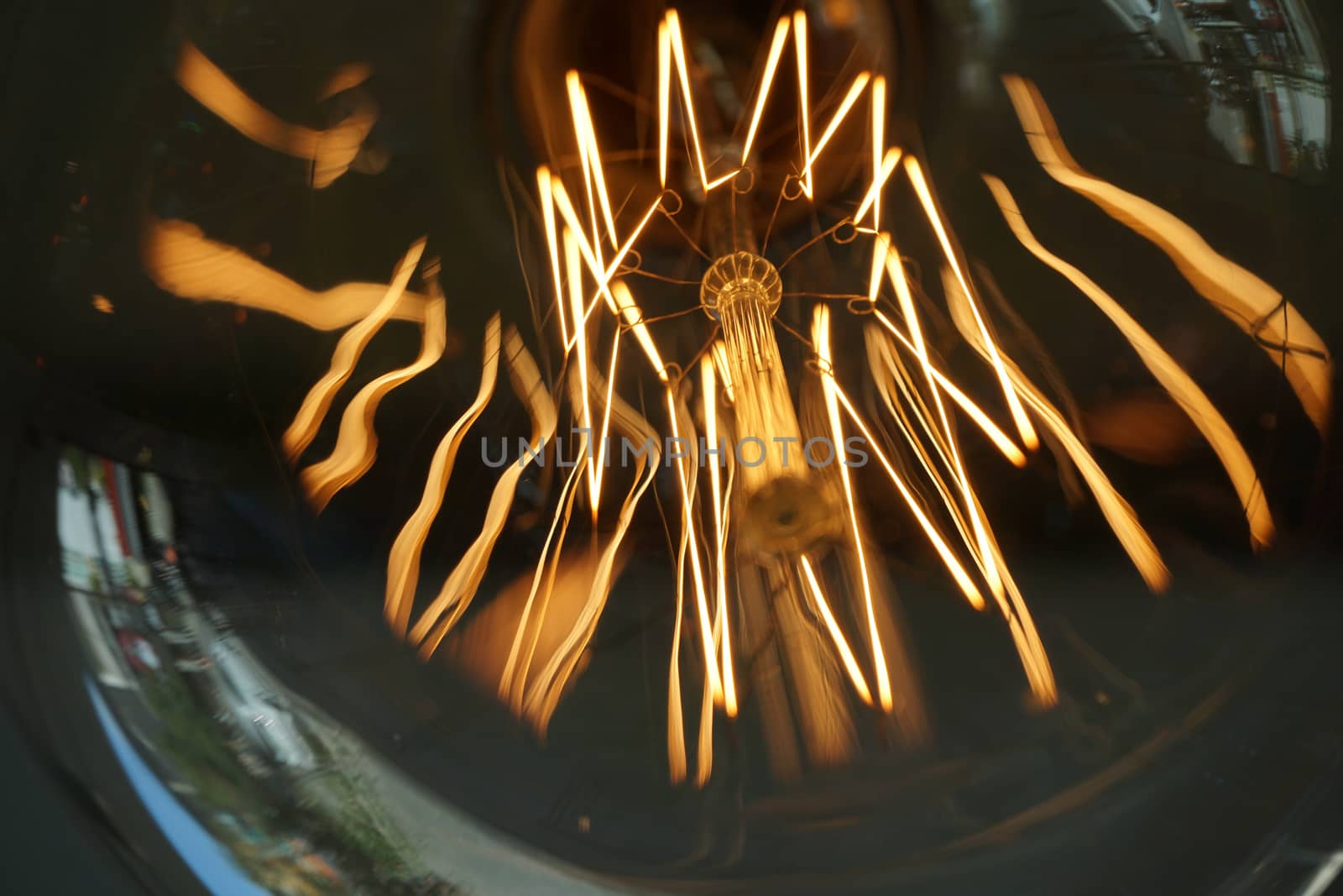 Amazing spiral electric current inside a retro crystal clear light bulb.