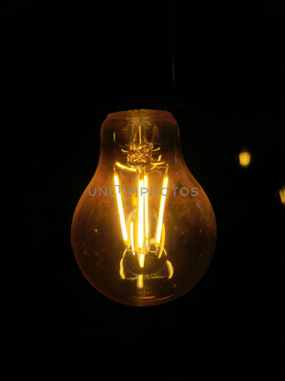 Amazing spiral electric current inside a retro crystal clear light bulb.