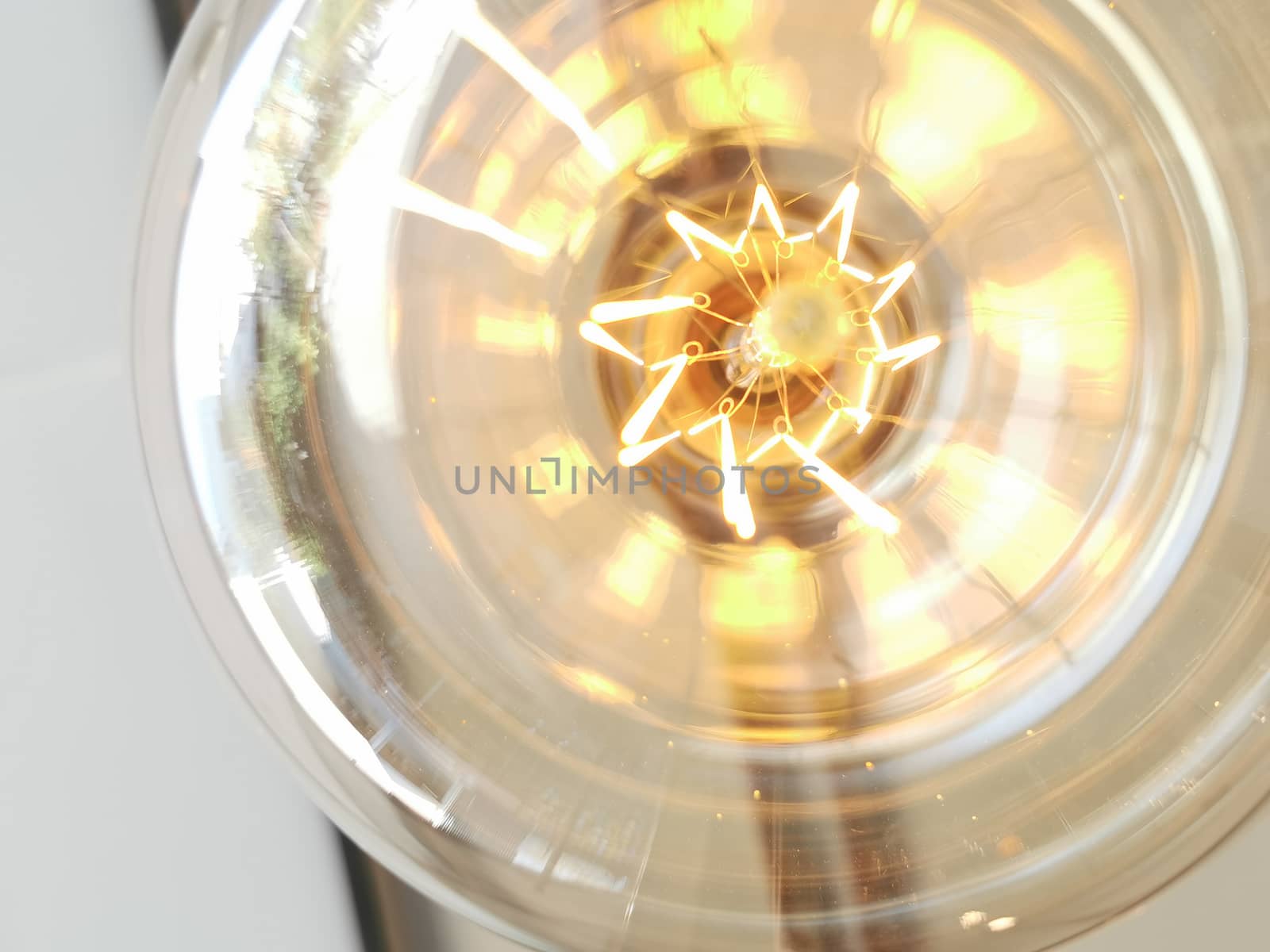 Amazing spiral electric current inside a retro crystal clear light bulb.