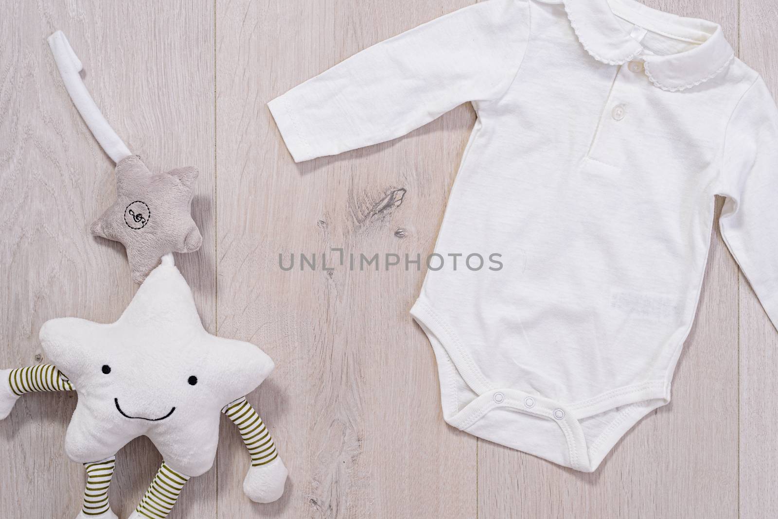 baby clothes concept. white suit for boy and girl on wooden background by jcdiazhidalgo