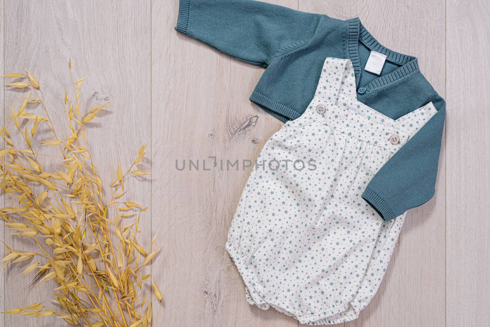 baby clothes concept. white and blue suit for boy on wooden background