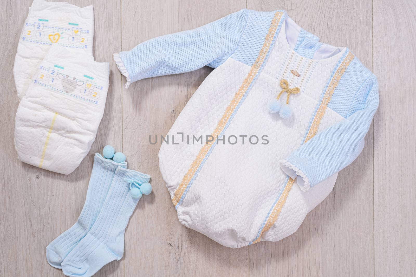 baby clothes concept. white and blue suit for boy on wooden background by jcdiazhidalgo
