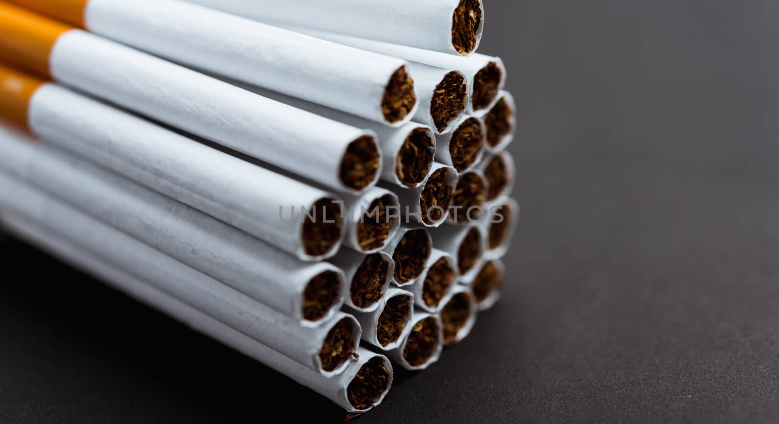 31 May of World No Tobacco Day, Close up front stack pile cigarette or tobacco on black background with copy space, Warning lung health concept