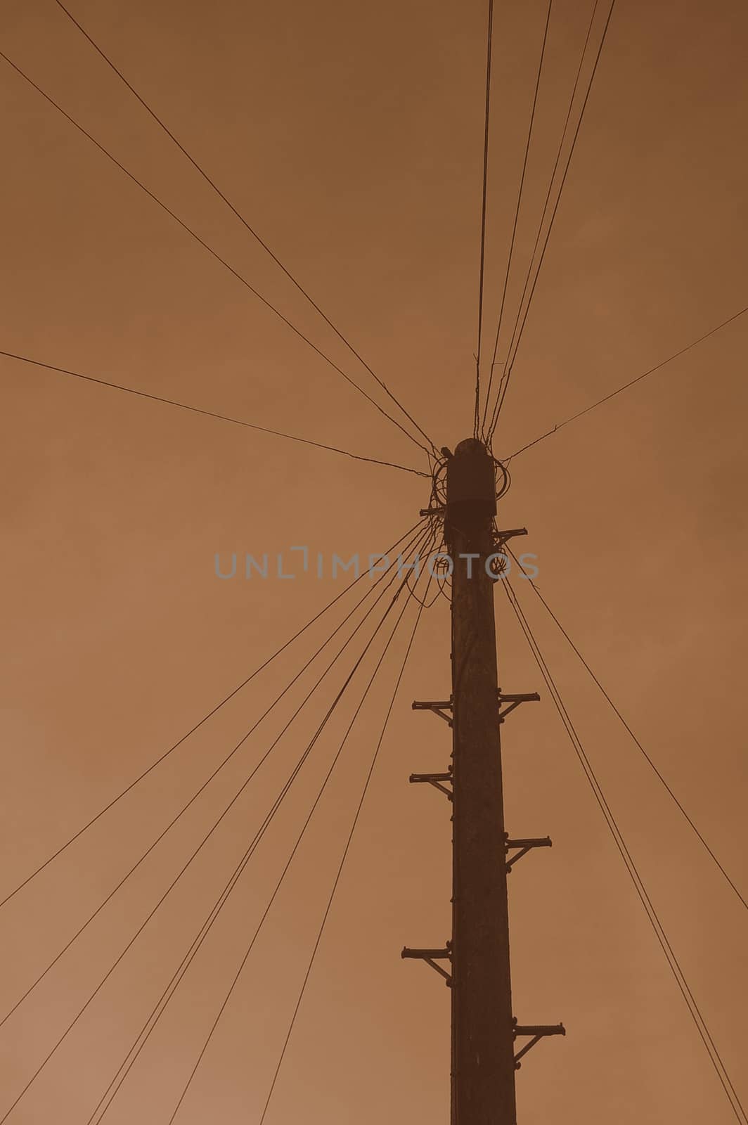 Sepia telegraph pole with numerous wires attached