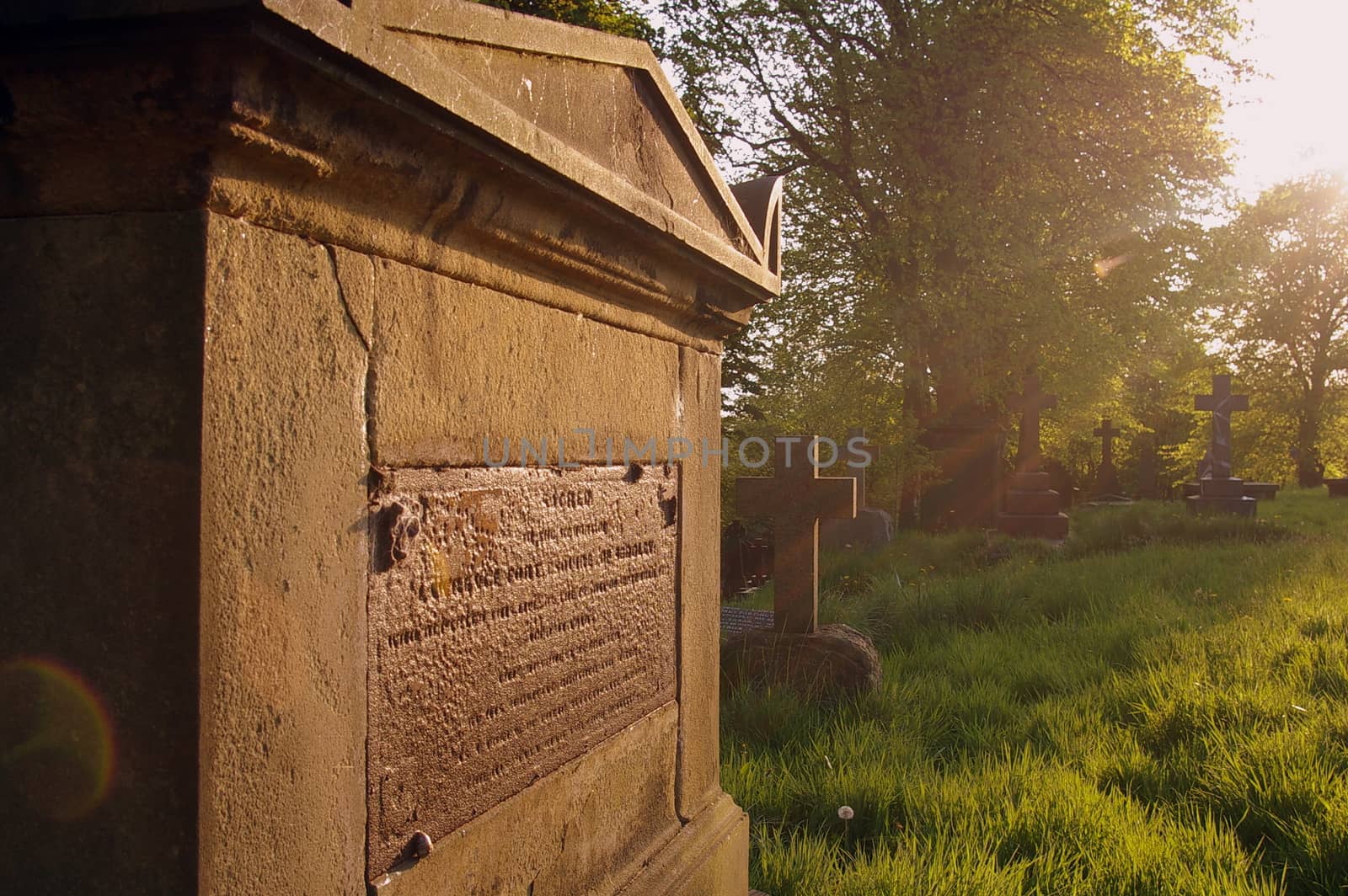 Tomb at sunset, in the graveyard of St. Mary's Church, Prestwich, Manchester, UK