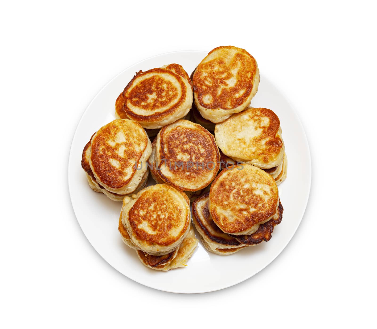 A pile of freshly baked pancakes lay on a plate isolated on white background. View from the top. With clipping path.