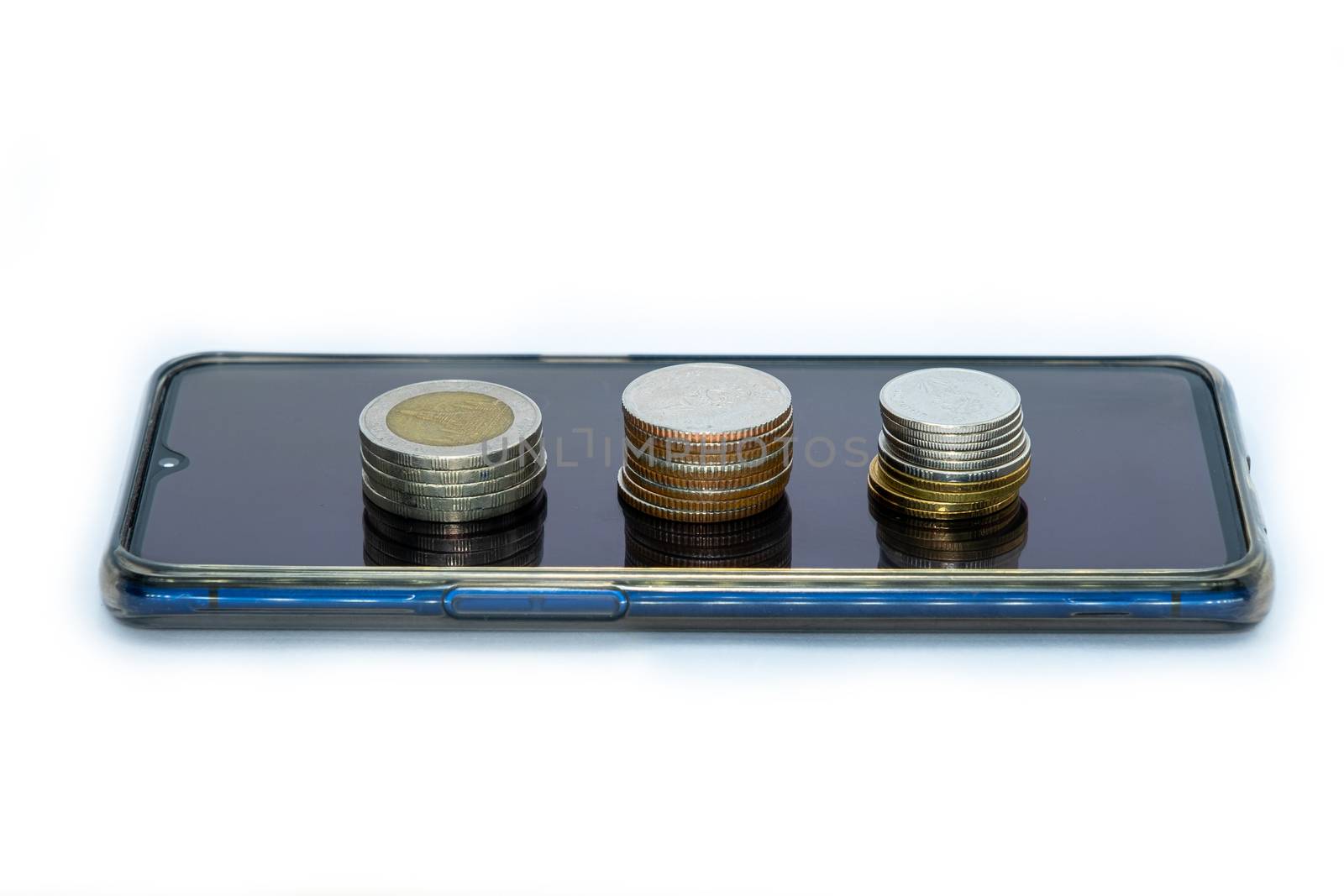 stack of coins on smart phone isolated on white background - business finance concept