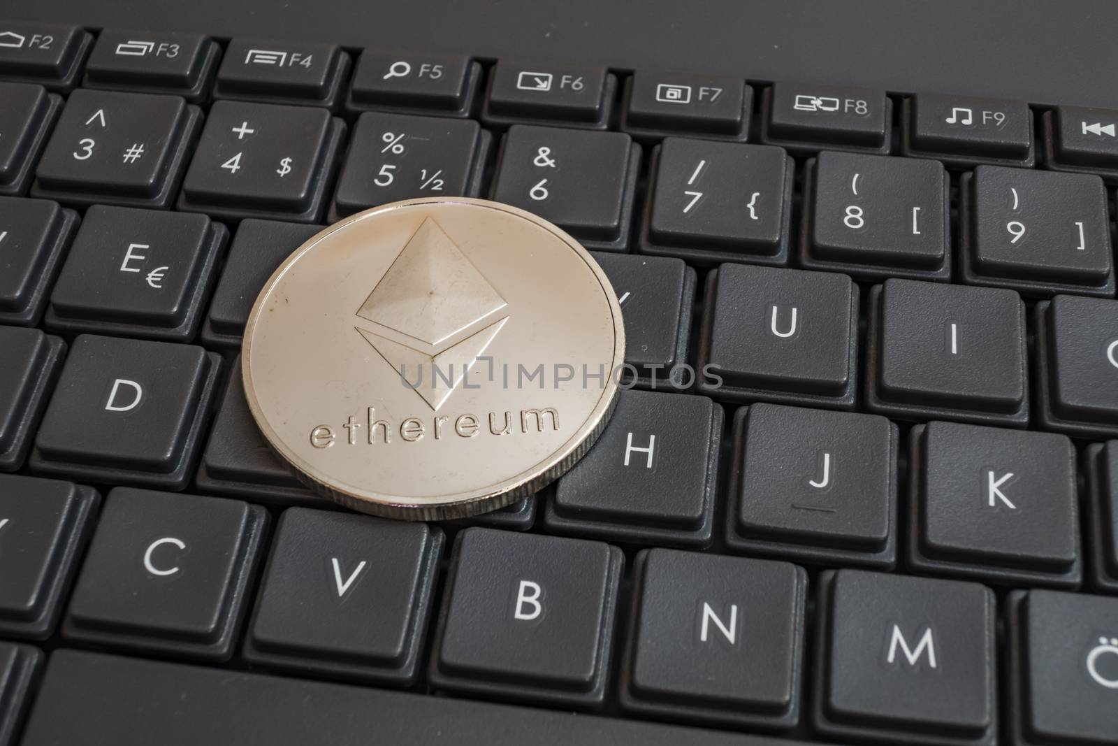 close up cryptocurrency coins on keyboard background