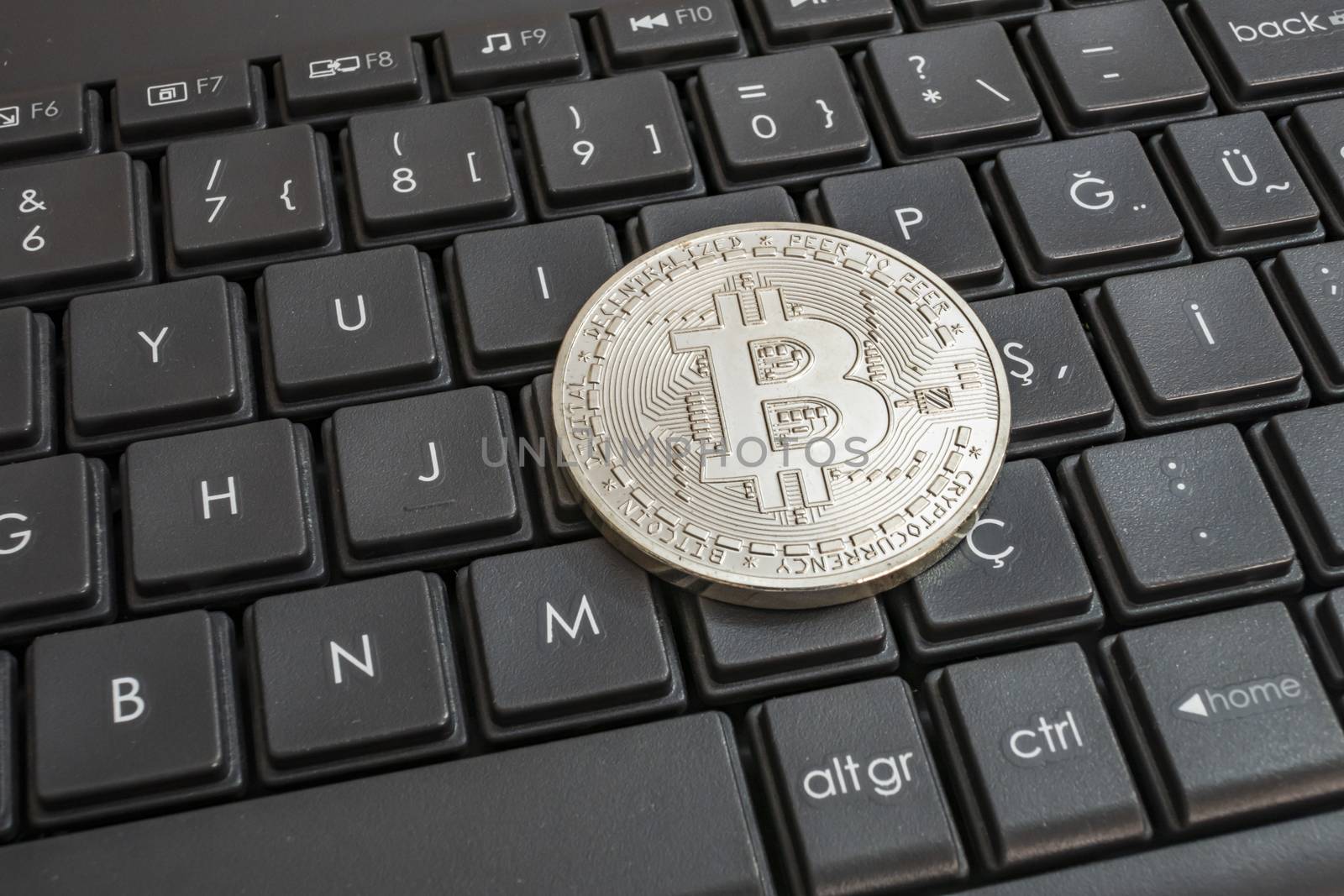 close up cryptocurrency coins on keyboard background