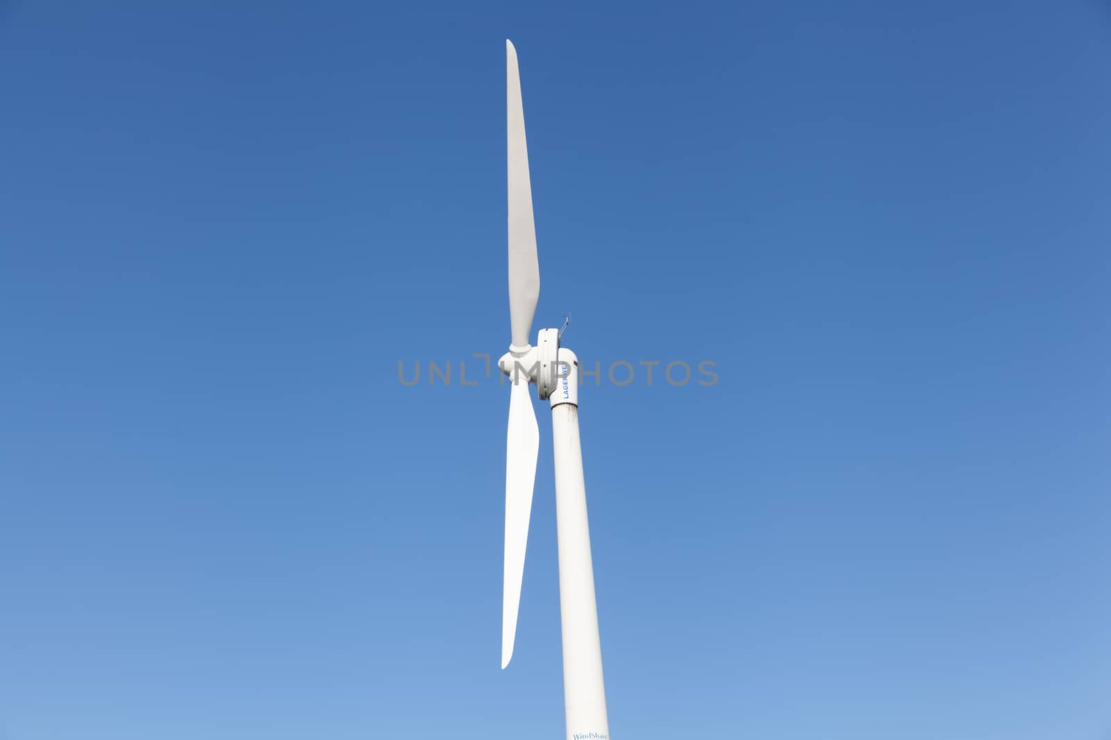 Wind energy: wind turbines and blue sky, renewable energy concept