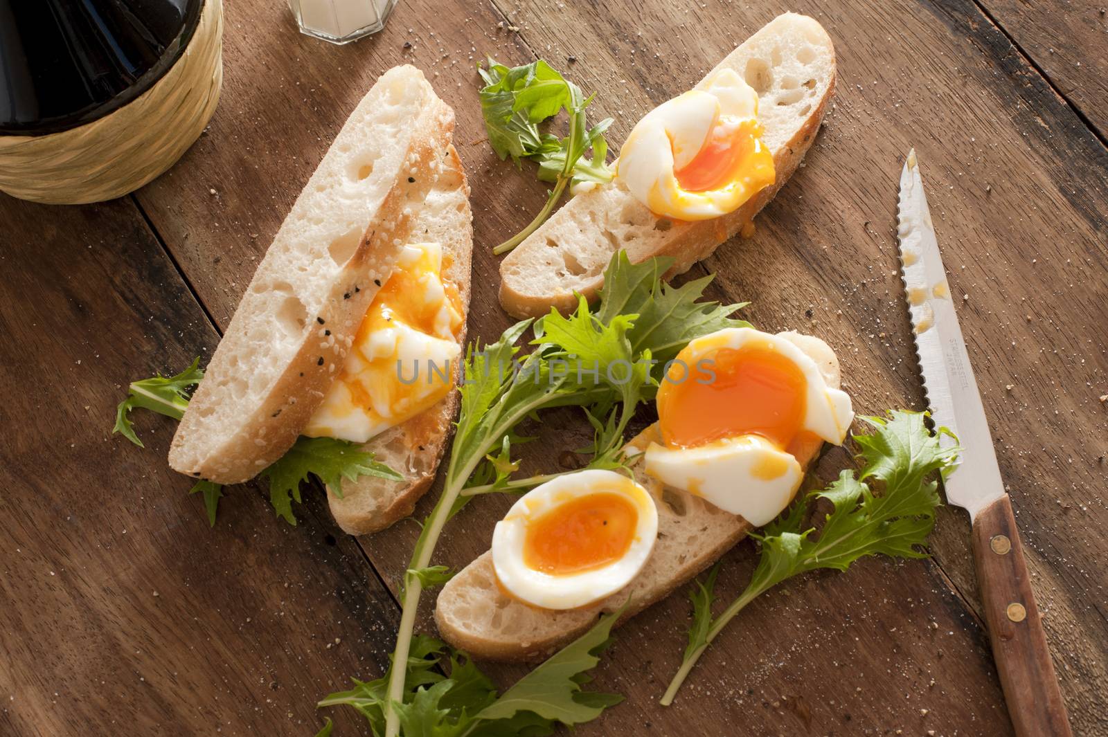 High angle view of fresh bread sices with boiled eggs and salad