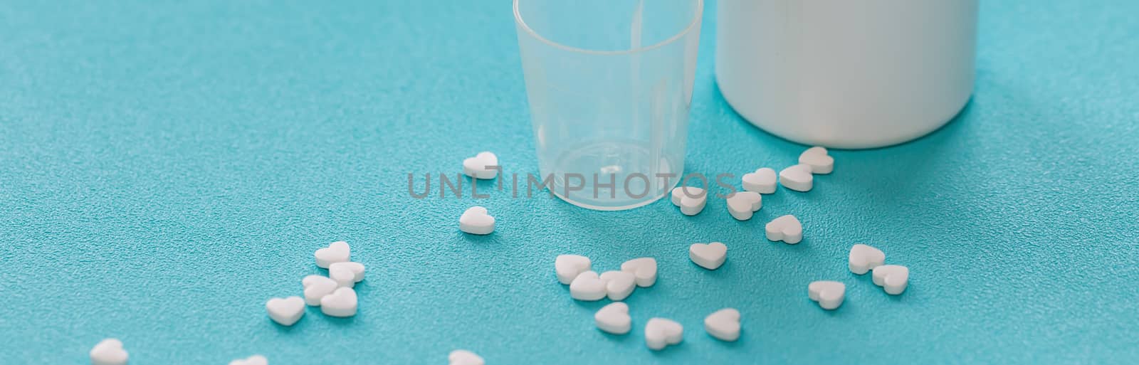 Vitamins and tablets , close-up. Blue background, place to insert text. Modern healthcare and pharmacy.