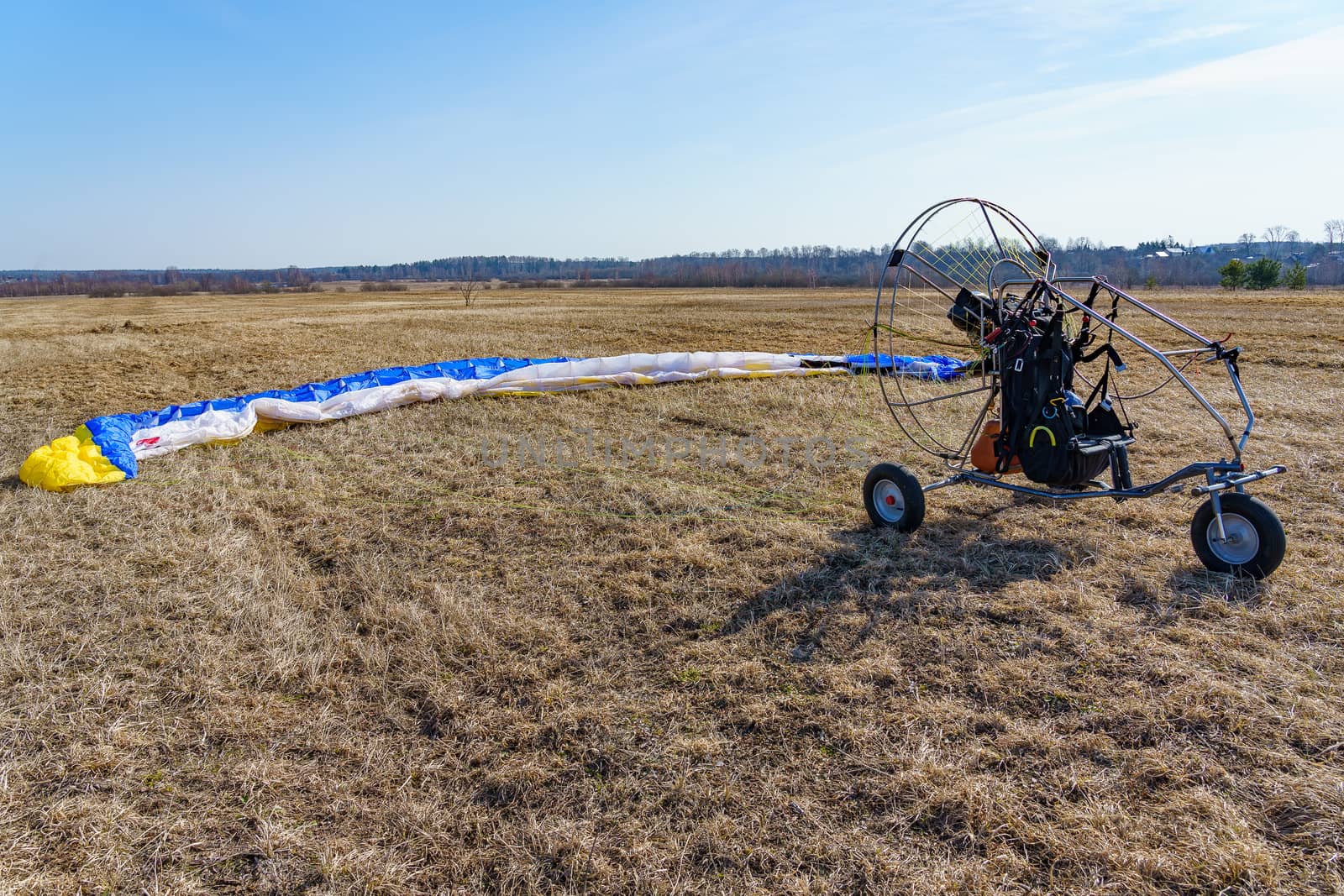 paraglider stands on the field prepared for flight by VADIM