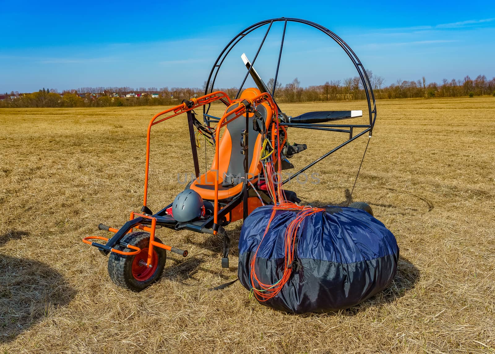 paraglider stands on the field prepared for flight by VADIM