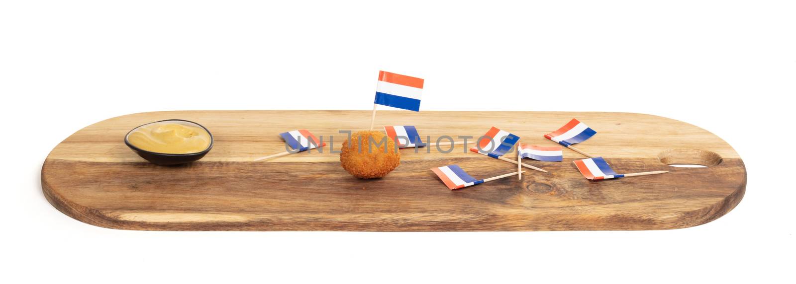 Dutch traditional snack bitterbal, just one left on a wooden serving board, isolated