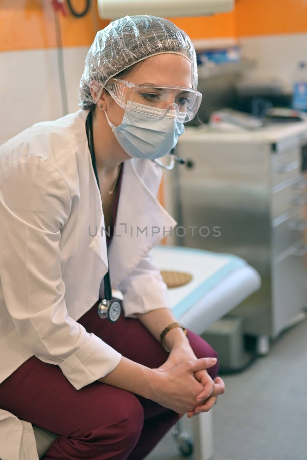 Stressed or tired young female doctor working in hospital