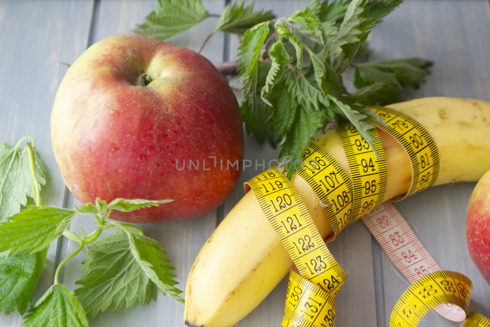 Vitamin fitness diet, red apple, nettle and banana with a centimeter tape mesure