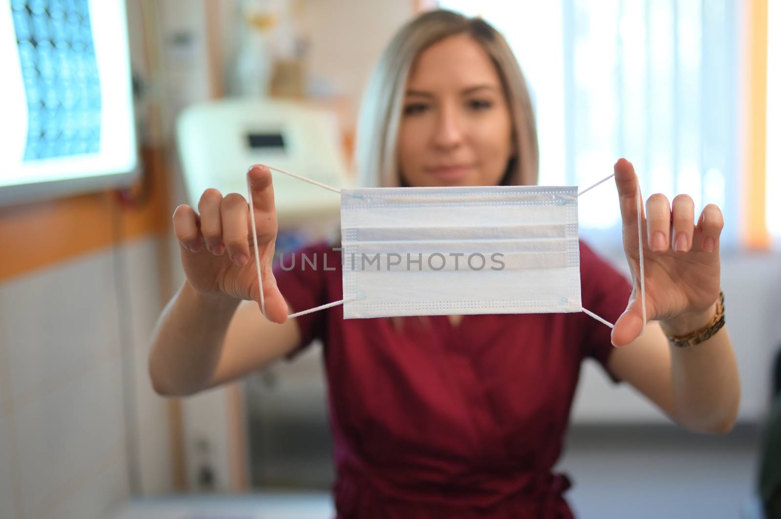 Young Woman Doctor Puts On A Protective Mask