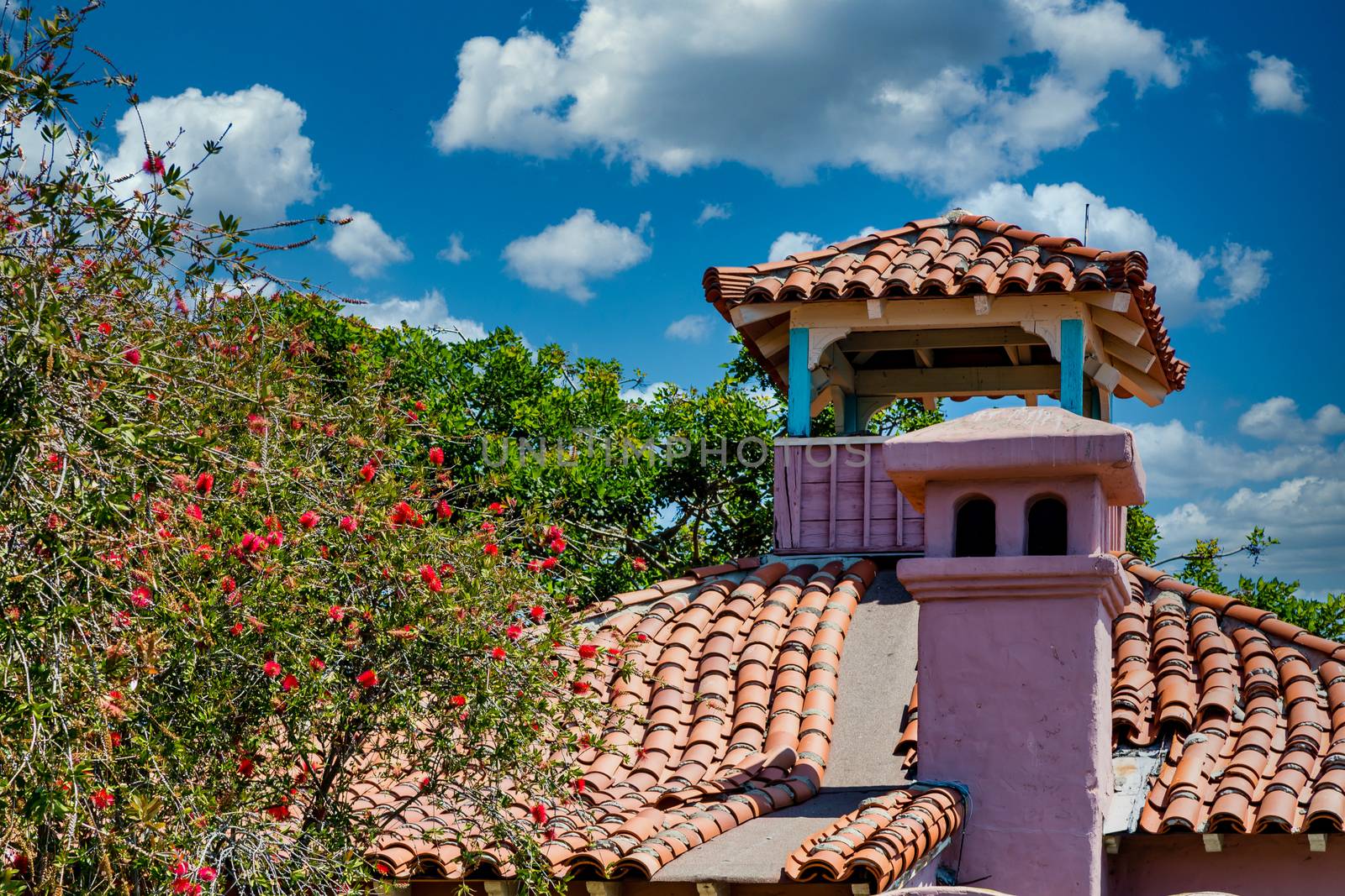 A red clay tile roof on a plaster hacienda