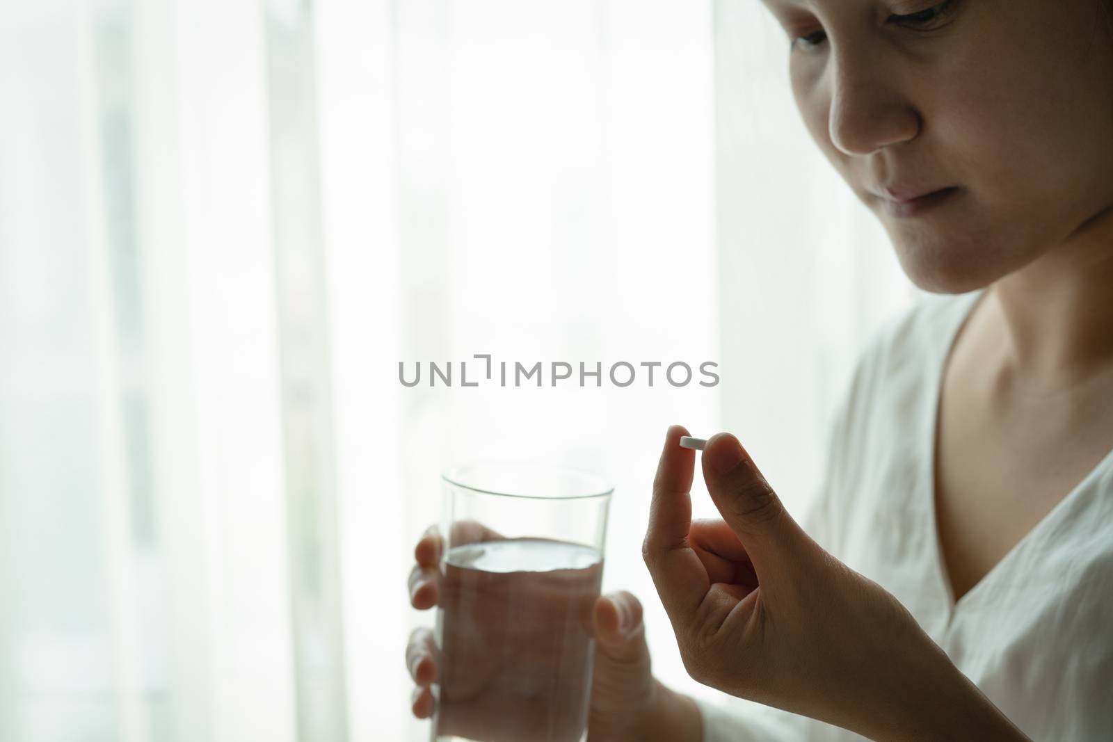 headache women hand hold medicine with a glass of water, healthcare and medicine recovery concept