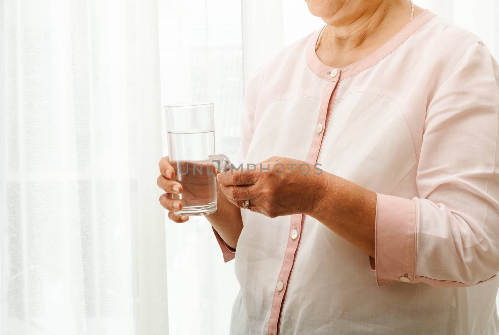 senior women take medicine with a glass of water, healthcare and medicine recovery concept