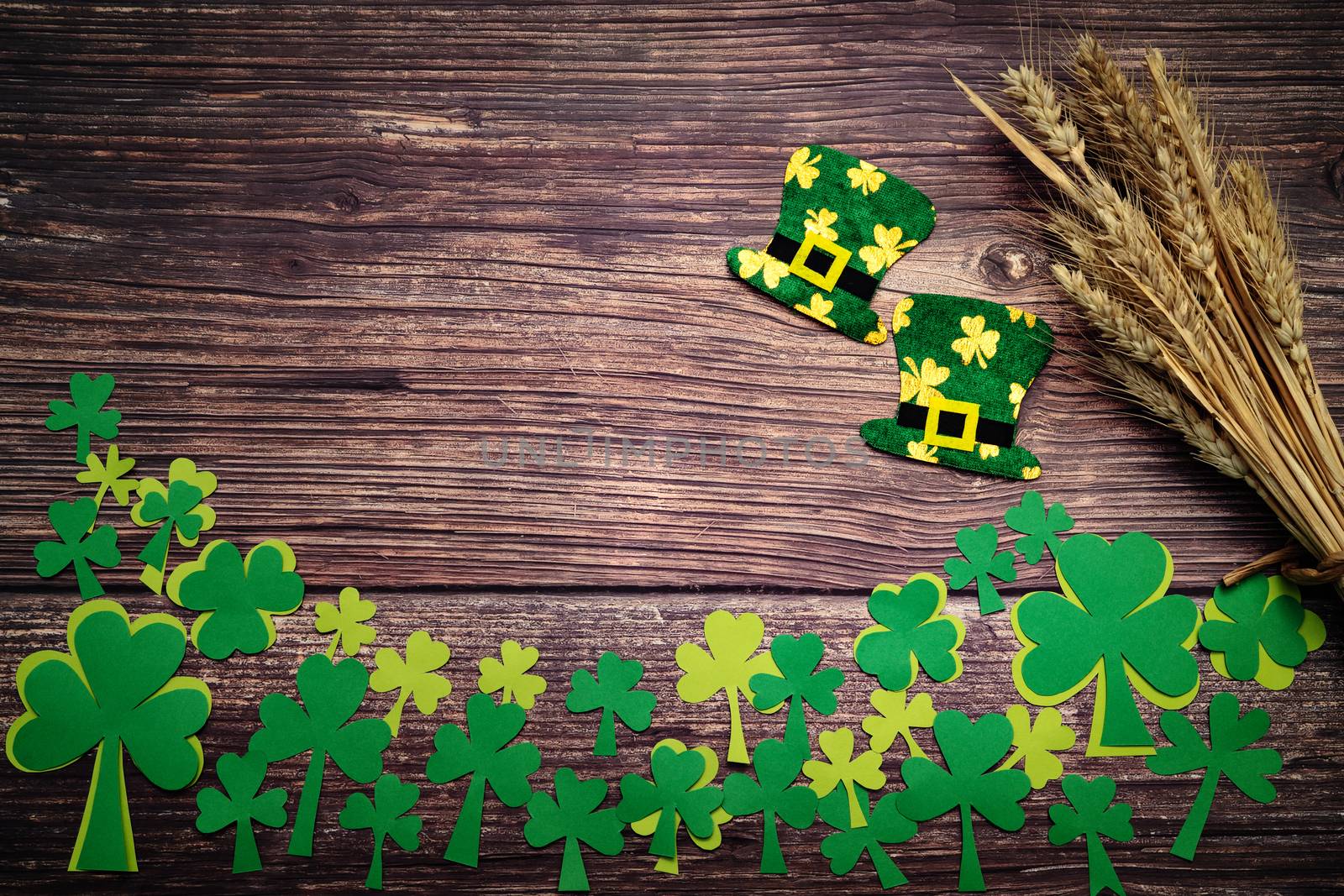 St Patricks day, golden coins, festive hat and green Shamrocks on wooden