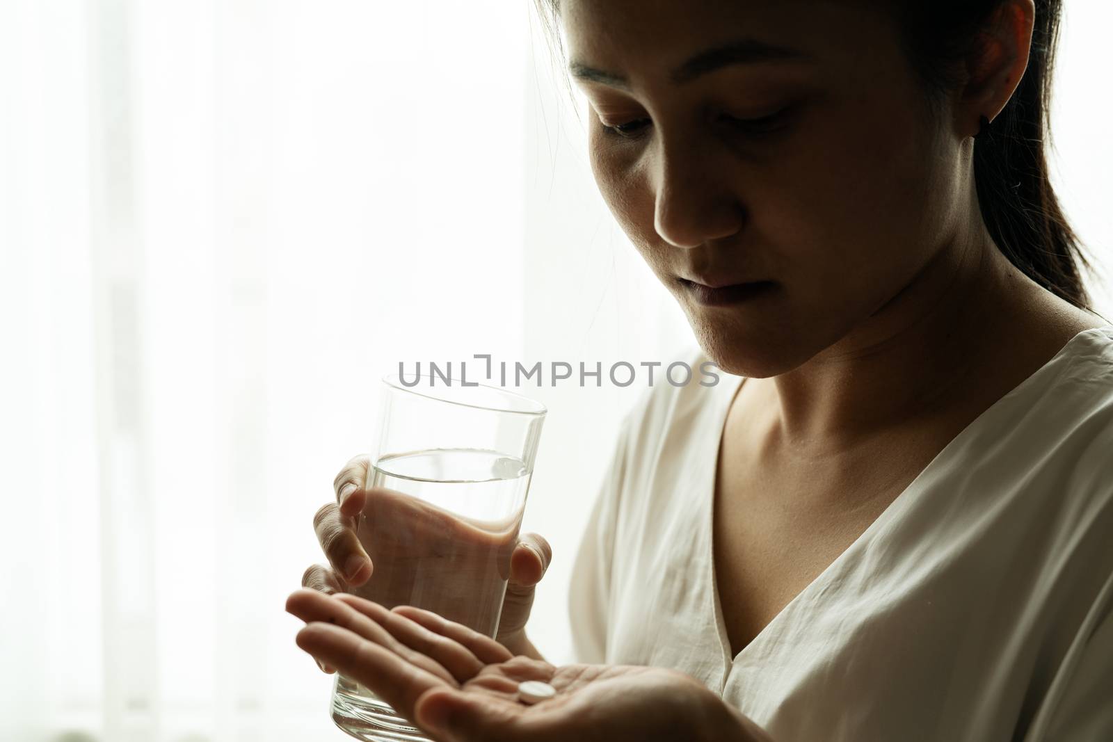 depressed women hand hold medicine with a glass of water, healthcare and medicine recovery concept