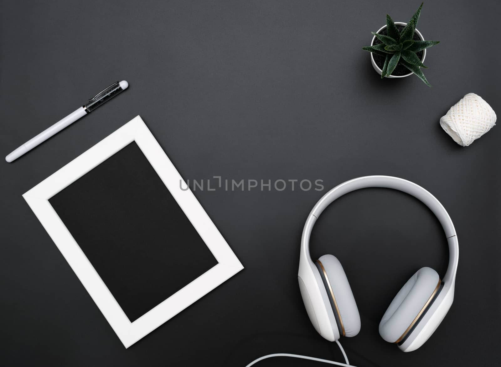 Mockup, Photo Frame, Headphones, Pen, and Cactus Write object on Black background