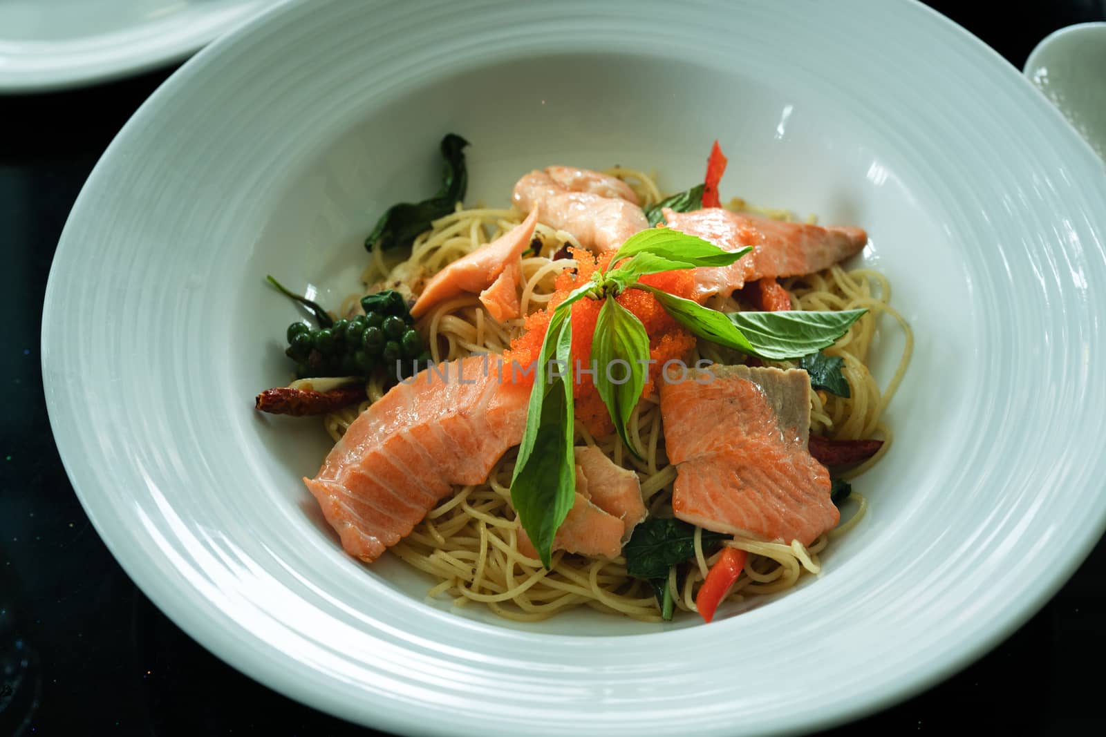 salmon spaghetti, smoked salmon and shrimp egg with spicy Thai herb. Home made food. Concept for a tasty and healthy meal, top view