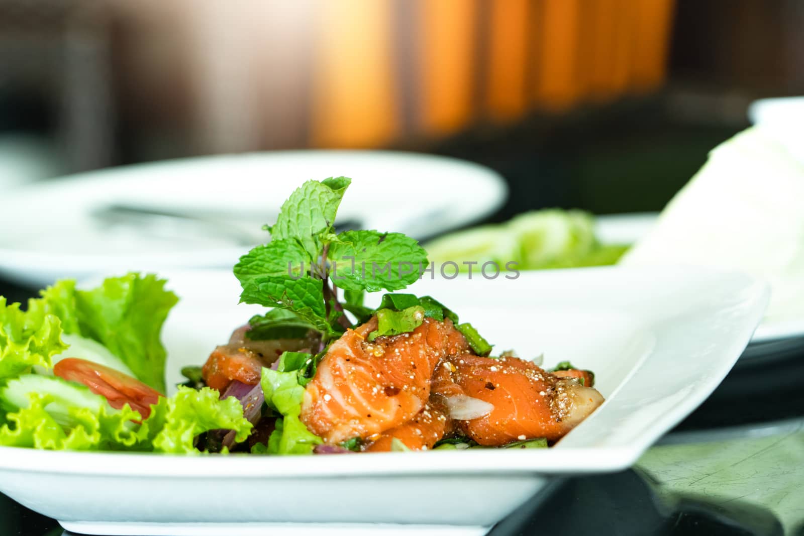 Spicy Salmon Salad with fresh mint and basil, Thai food style. Home made food. Concept for a tasty and healthy meal
