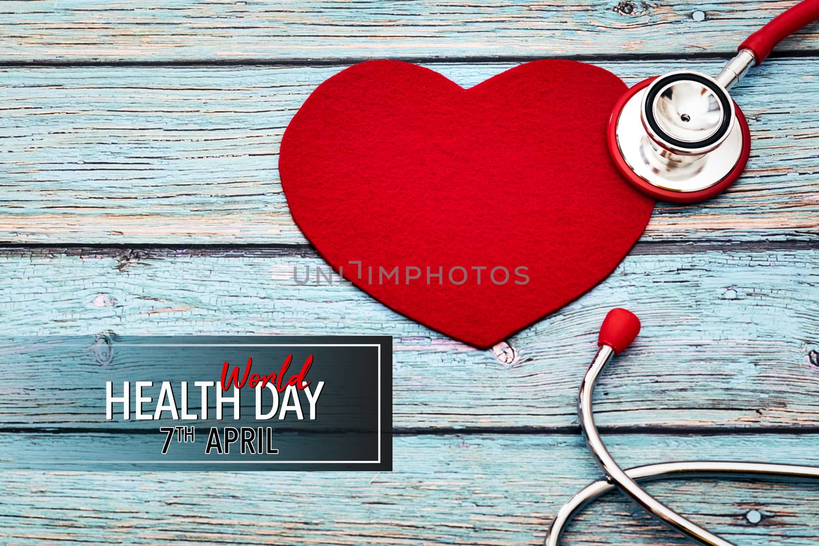 World health day, healthcare and medical concept, red stethoscope and red heart on the blue wooden background