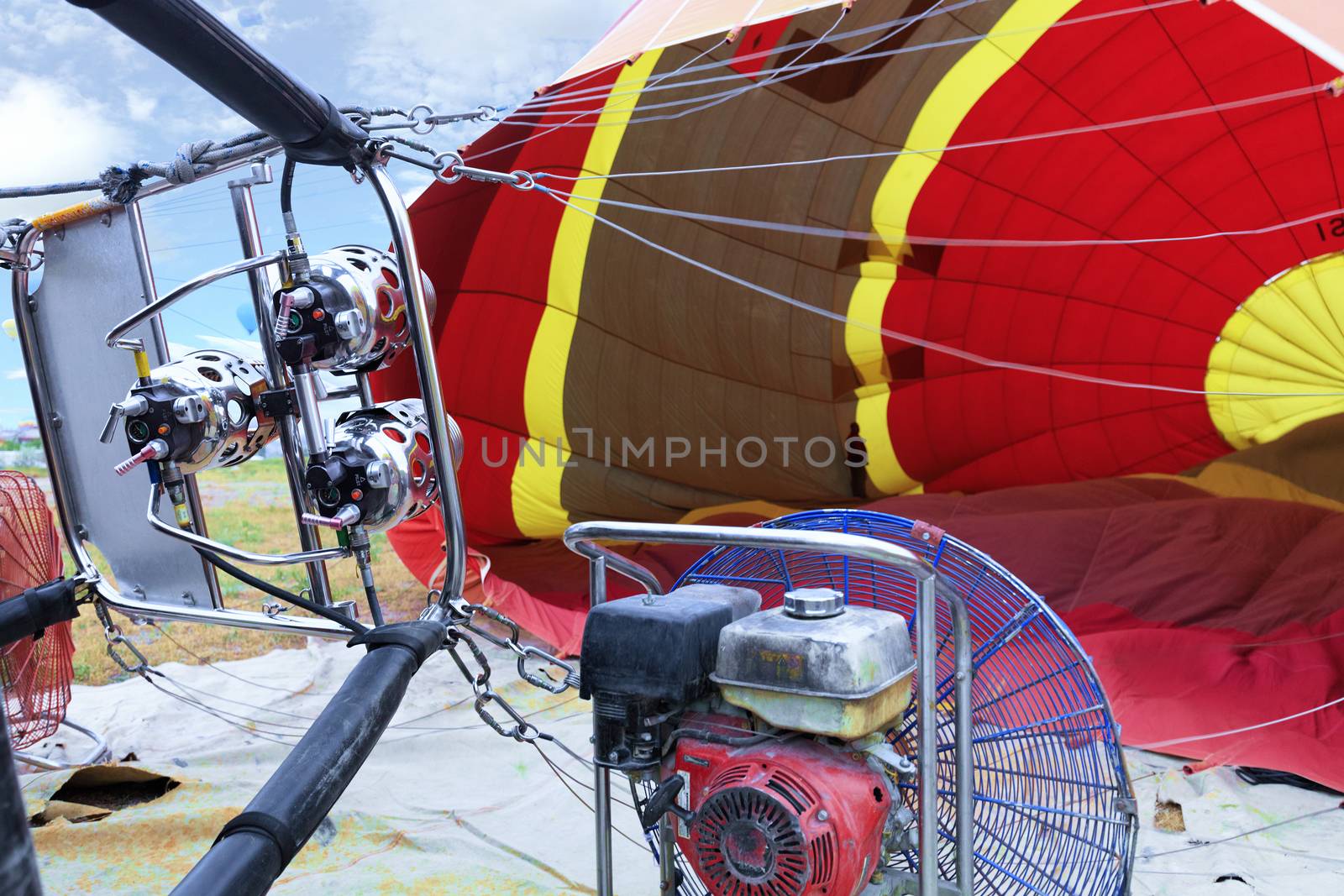 The process of inflating cylinders with a gasoline fan and a gas burner close-up. by Sergii