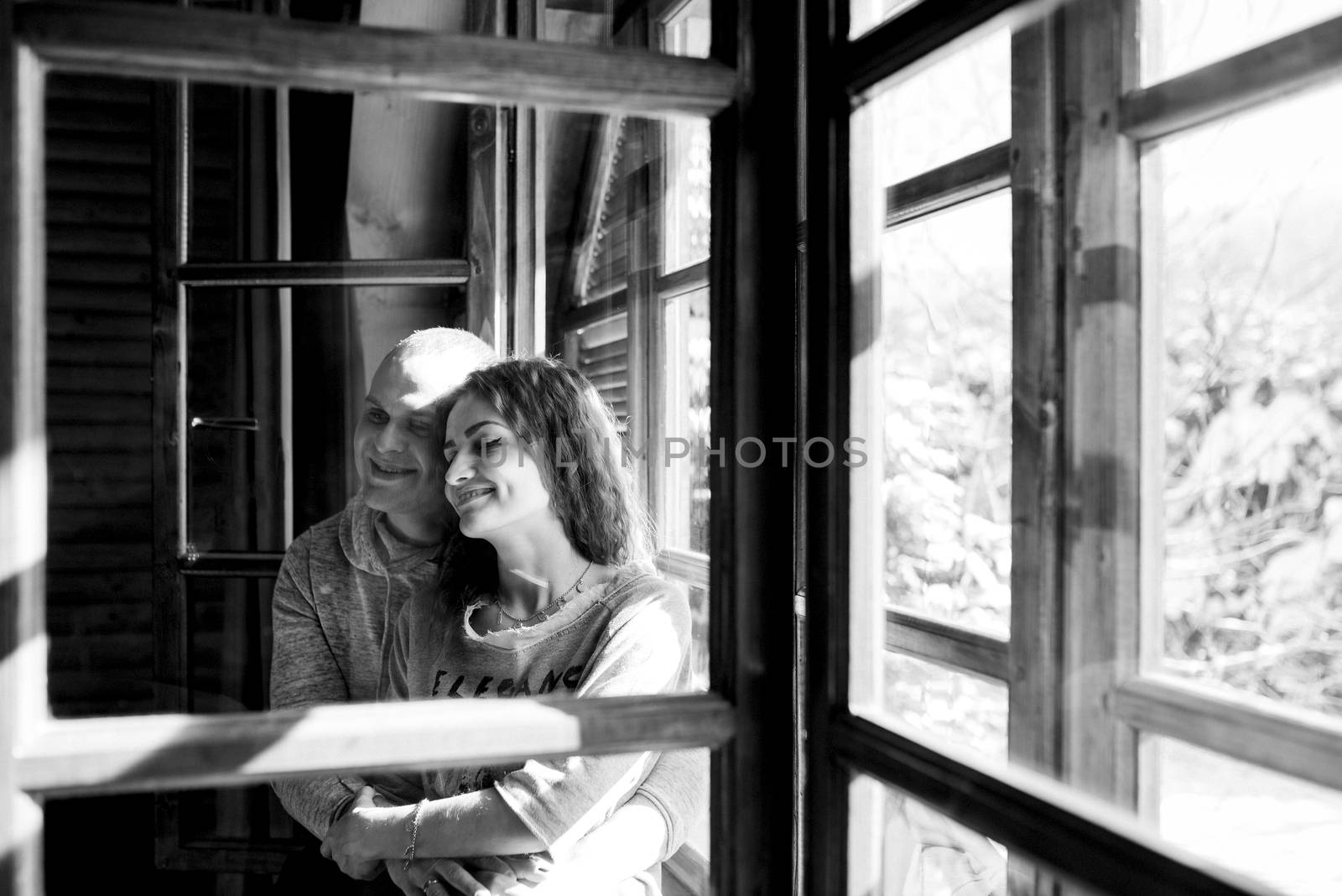 guy and girl in the house near the window overlooking a snowy landscape