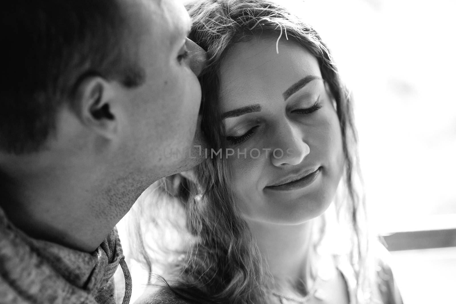 guy and girl in the house near the window overlooking a snowy landscape