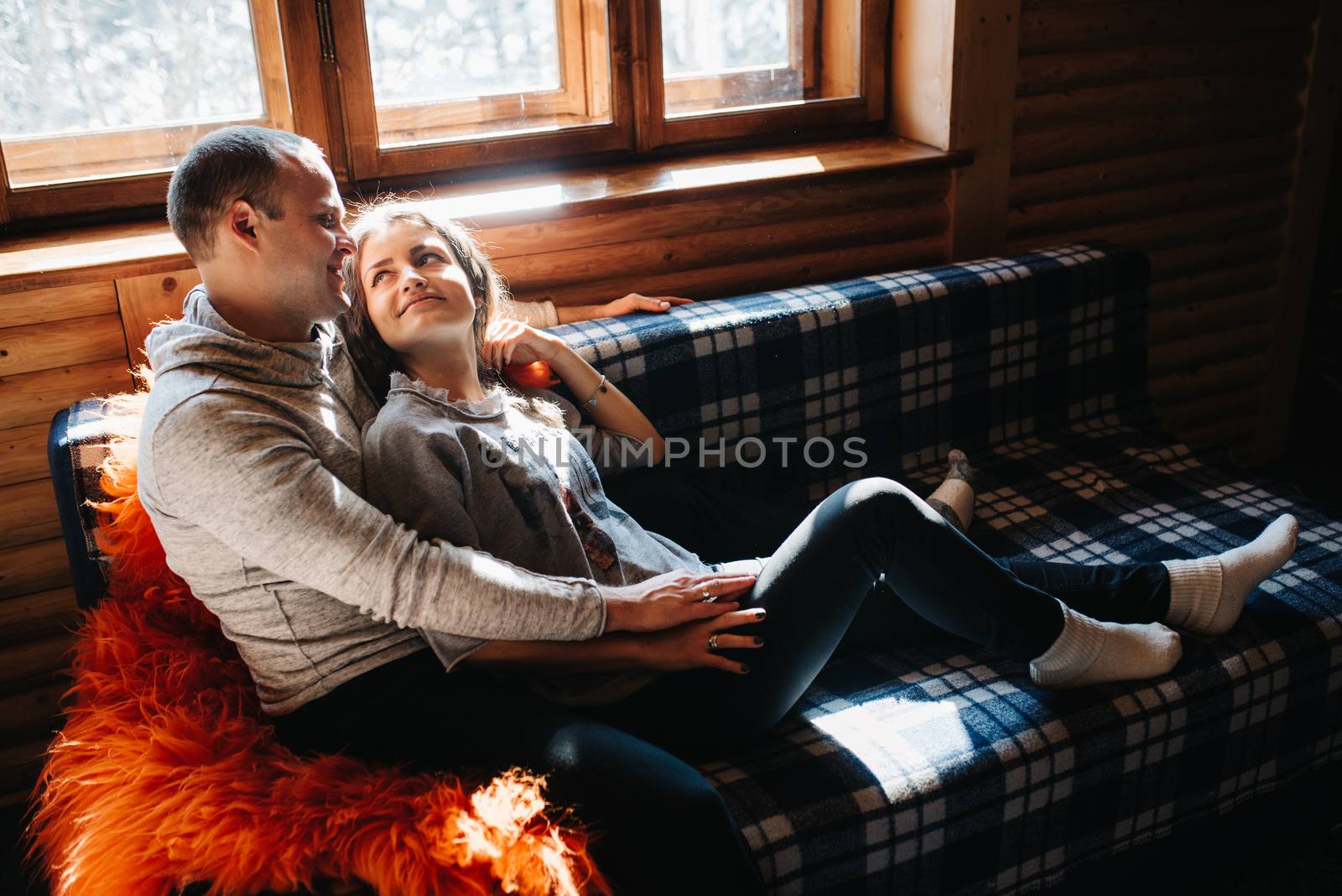 guy and girl in the house near the window overlooking a snowy landscape