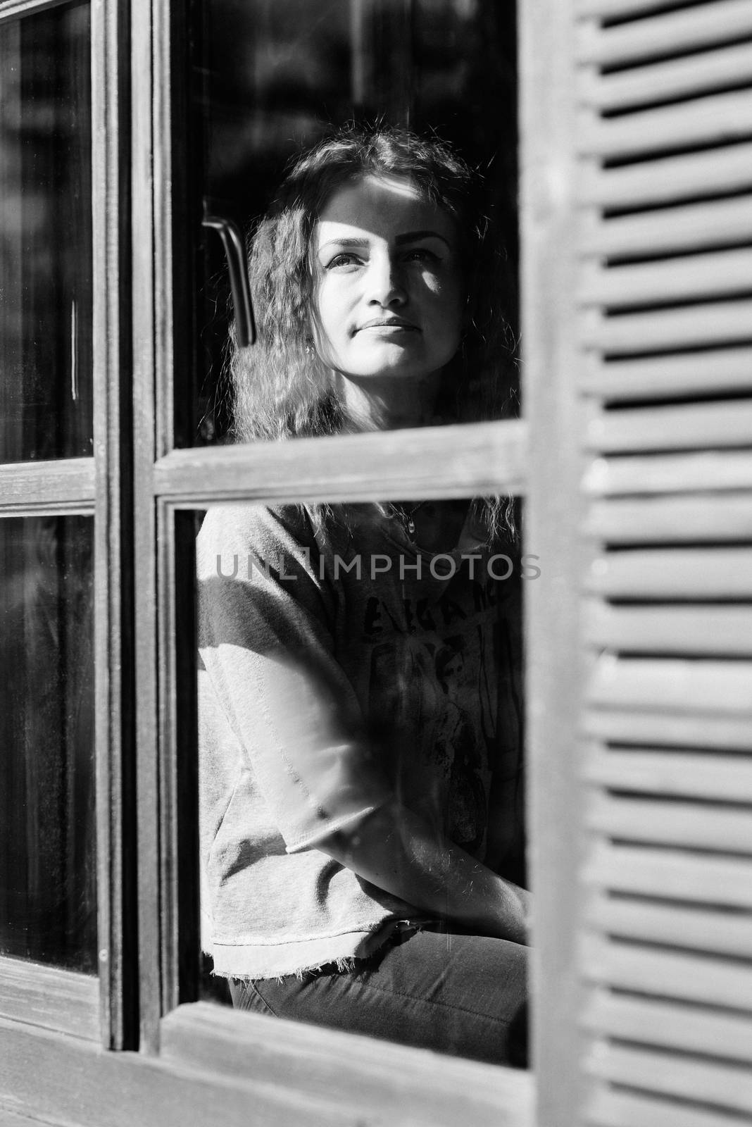 girl in the house near the window overlooking a snowy landscape