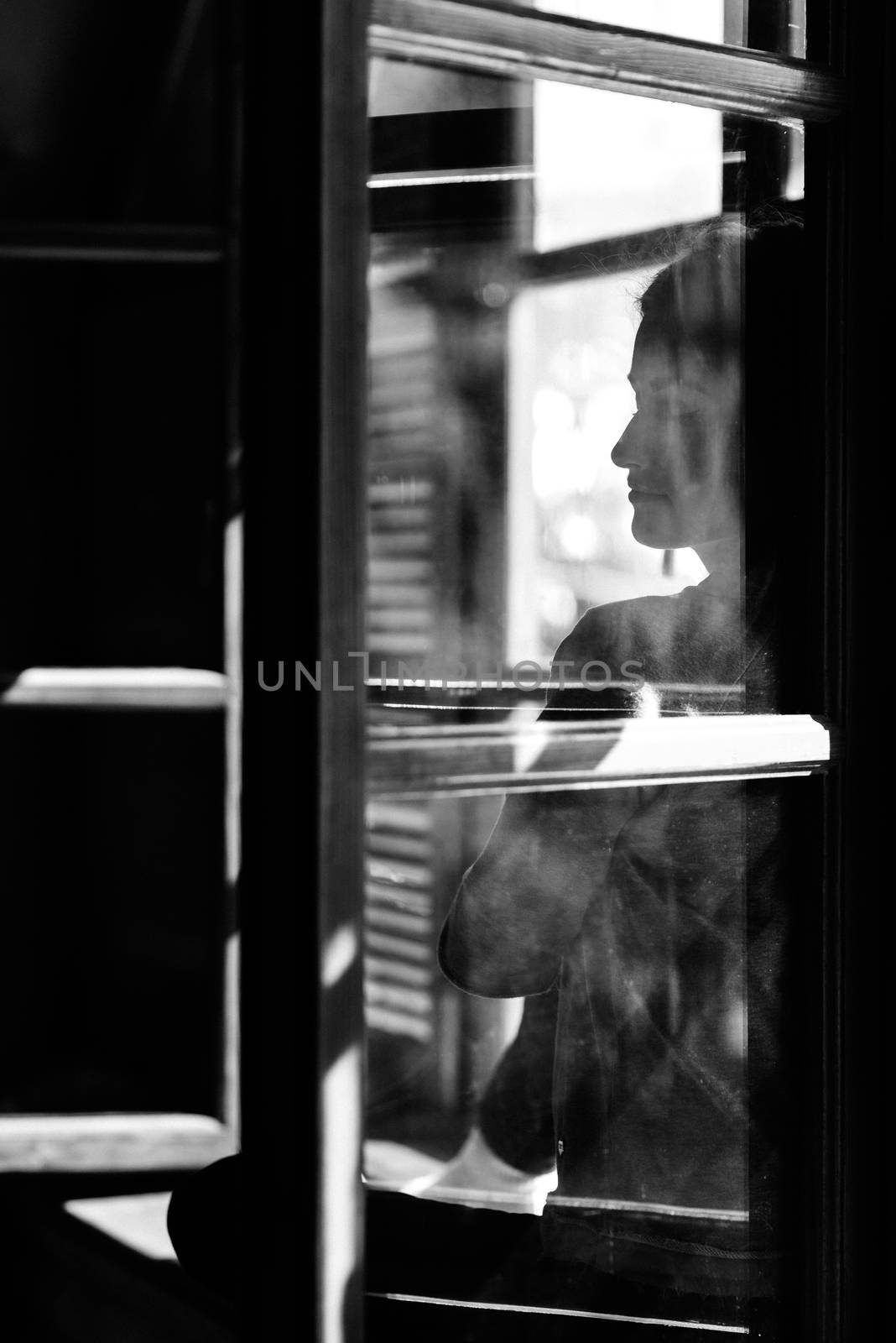 girl in the house near the window overlooking a snowy landscape