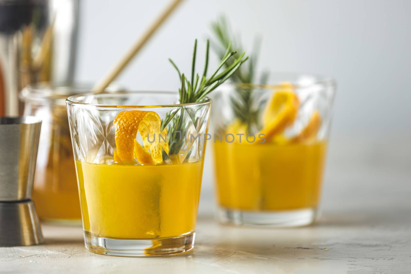 Two glasses of honey bourbon cocktail with rosemary simple syrup by ArtSvitlyna