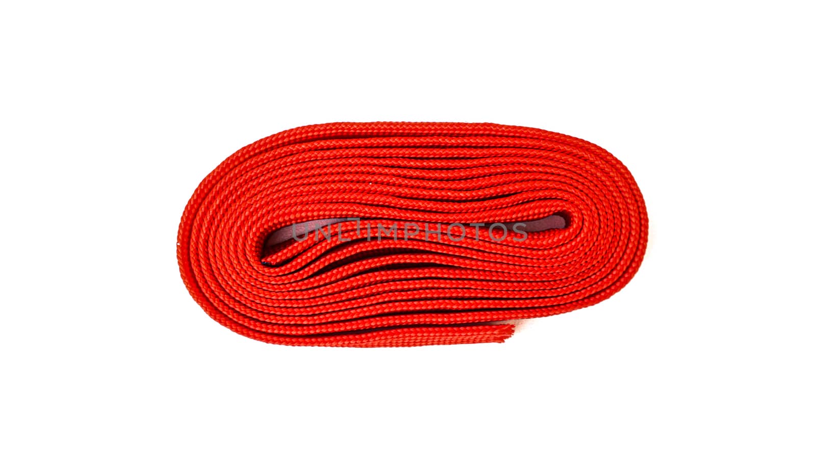 Red rope on white background. Fabric rope in red color folded in by sonandonures