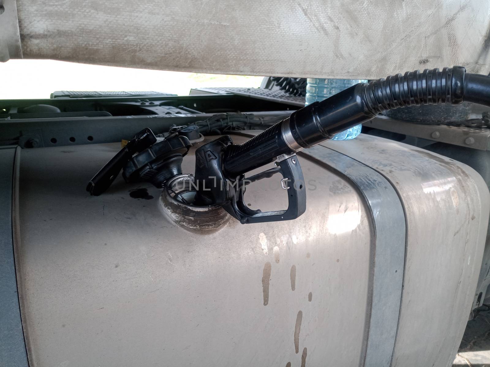 Diesel refueling gun in a truck tank.