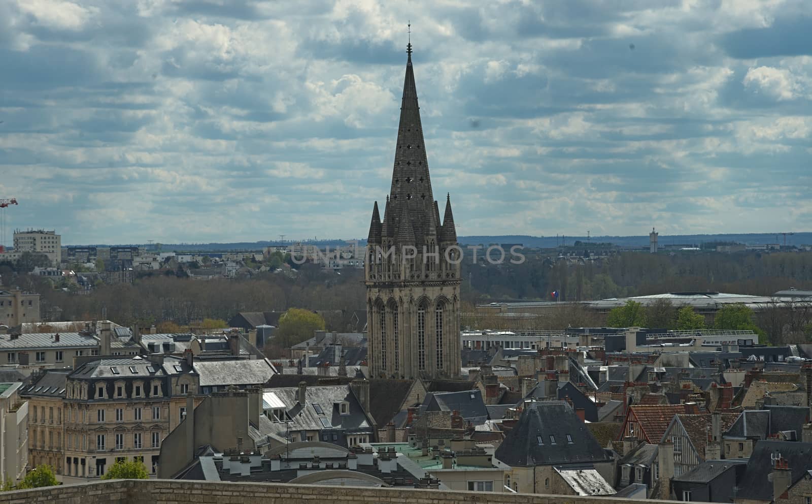 Cityscape of French city Caen with high tower of an catholic cathedral