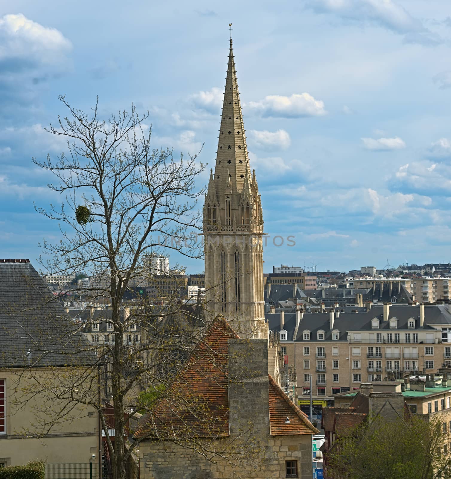 View on tall bell tower of an Catholic cathedral in Caen, France from fortress by sheriffkule