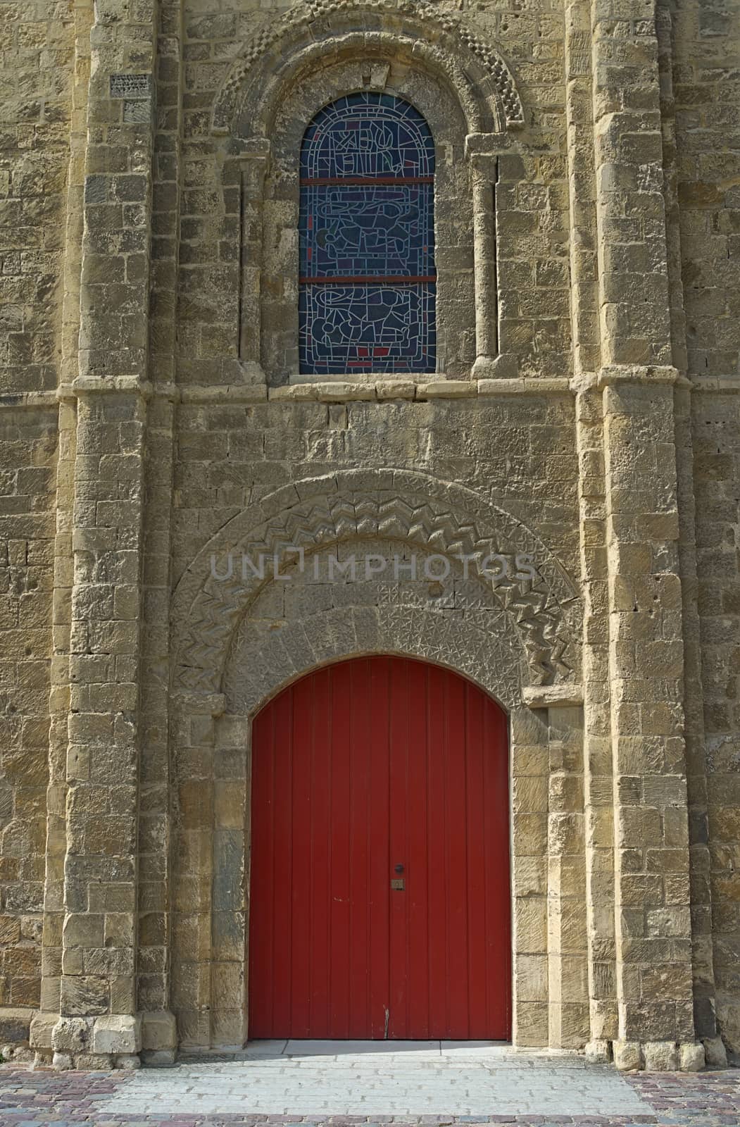 View on red gate and window at gothic style catholic church entrance by sheriffkule