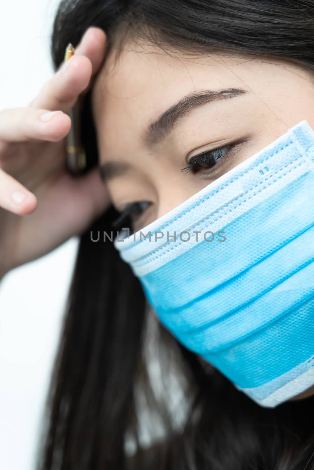 Close up woman with headache wearing mask for protect Covid-19 by stoonn