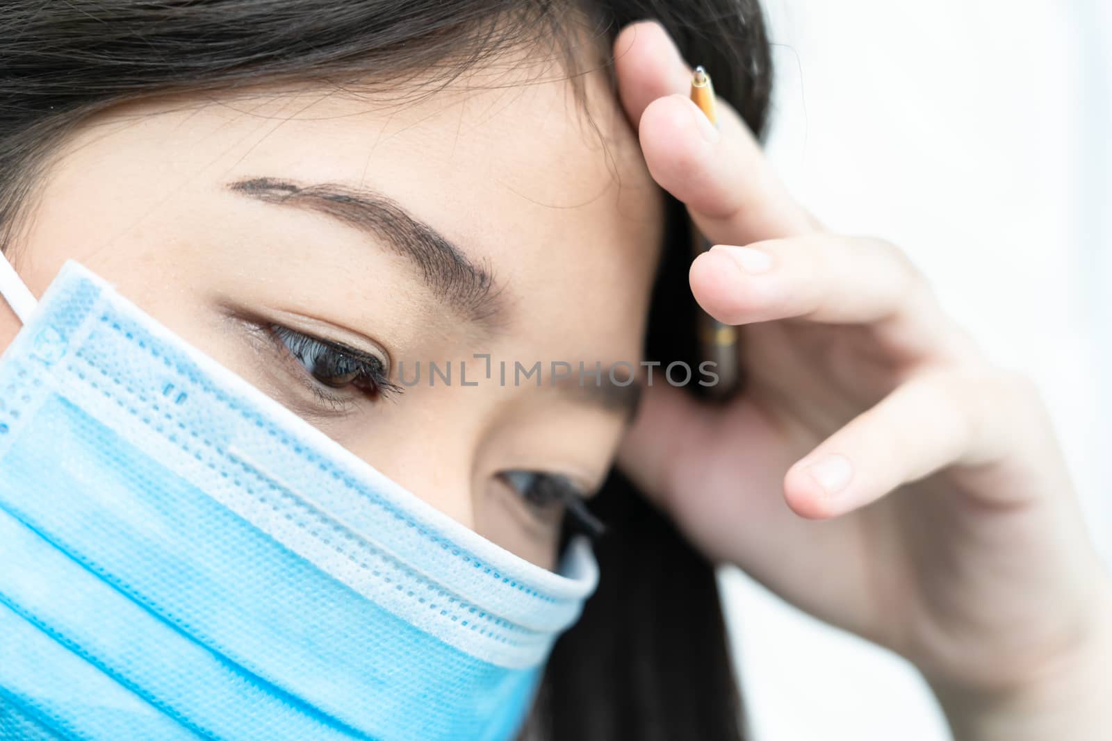 Close up woman with headache wearing  protective mask  for protection against virus Covid-19
