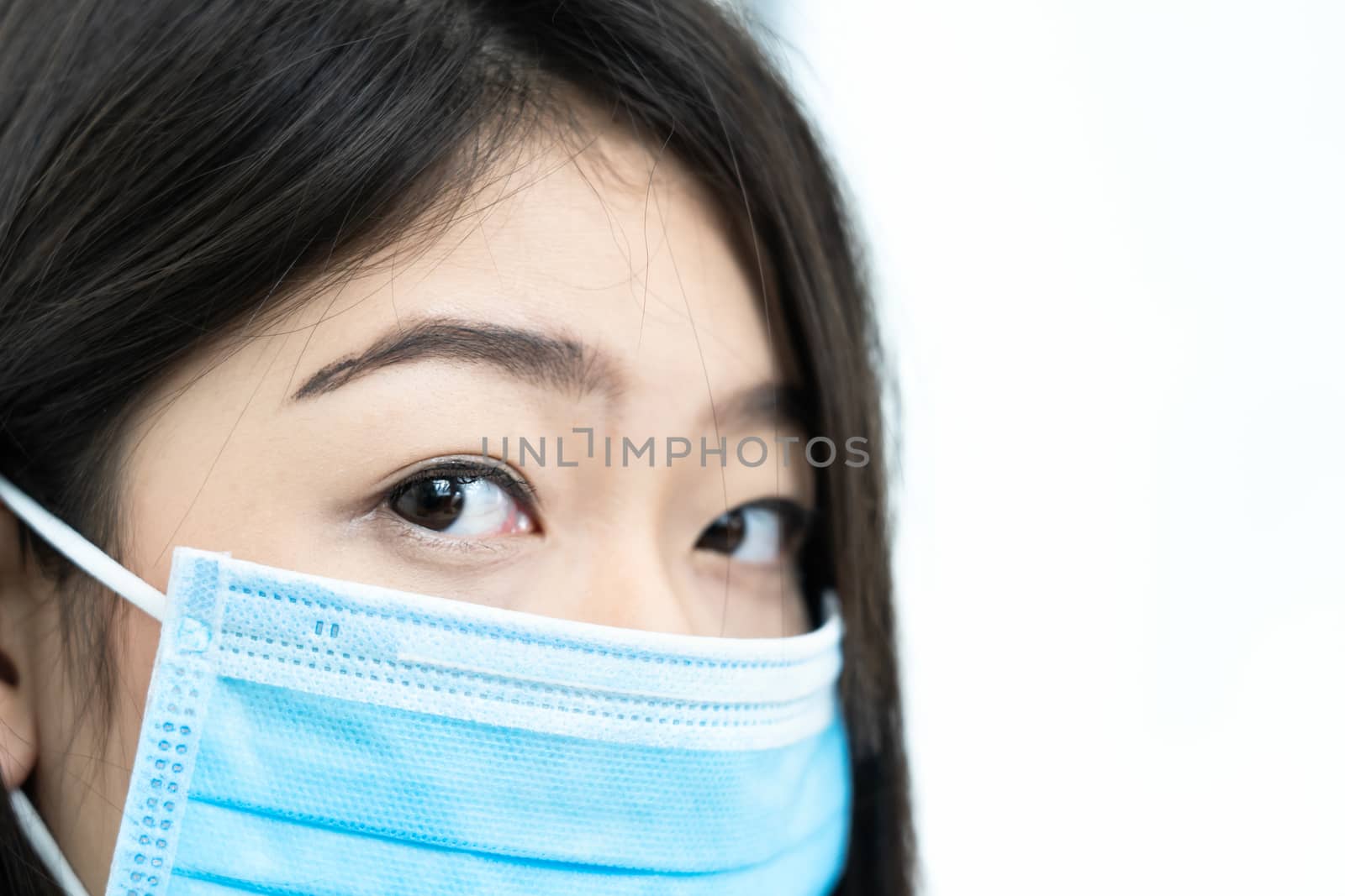 Close up woman with headache wearing  protective mask  for protection against virus Covid-19