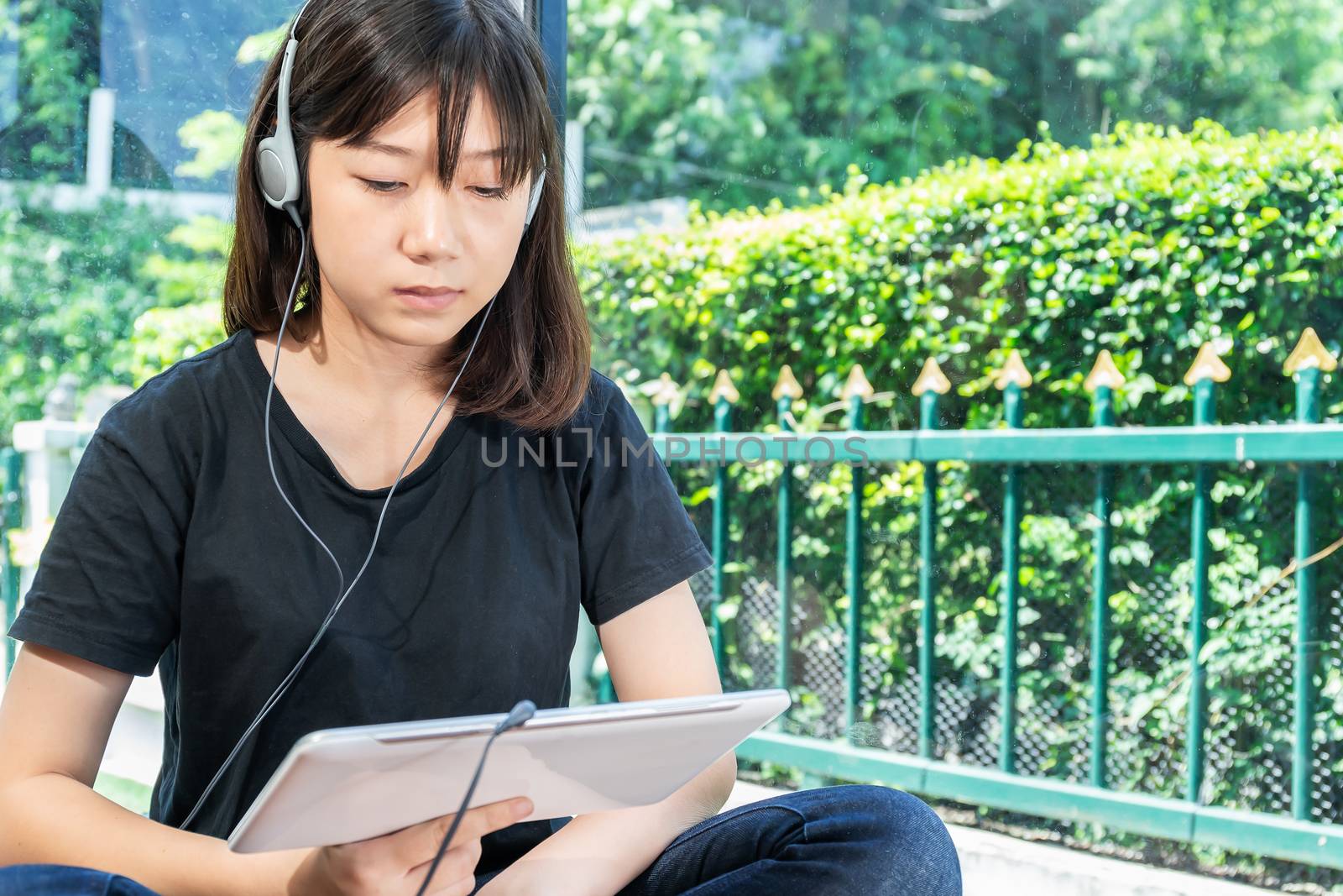 Happy teenage female  learning to the music from a digital tablet in room at home